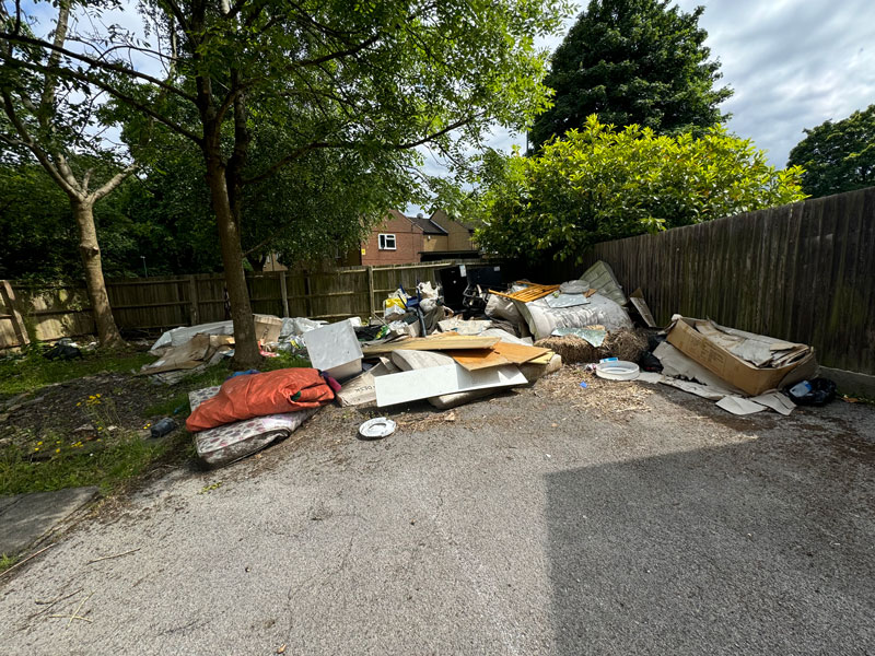 Rubbish scattered on driveway at end of garden